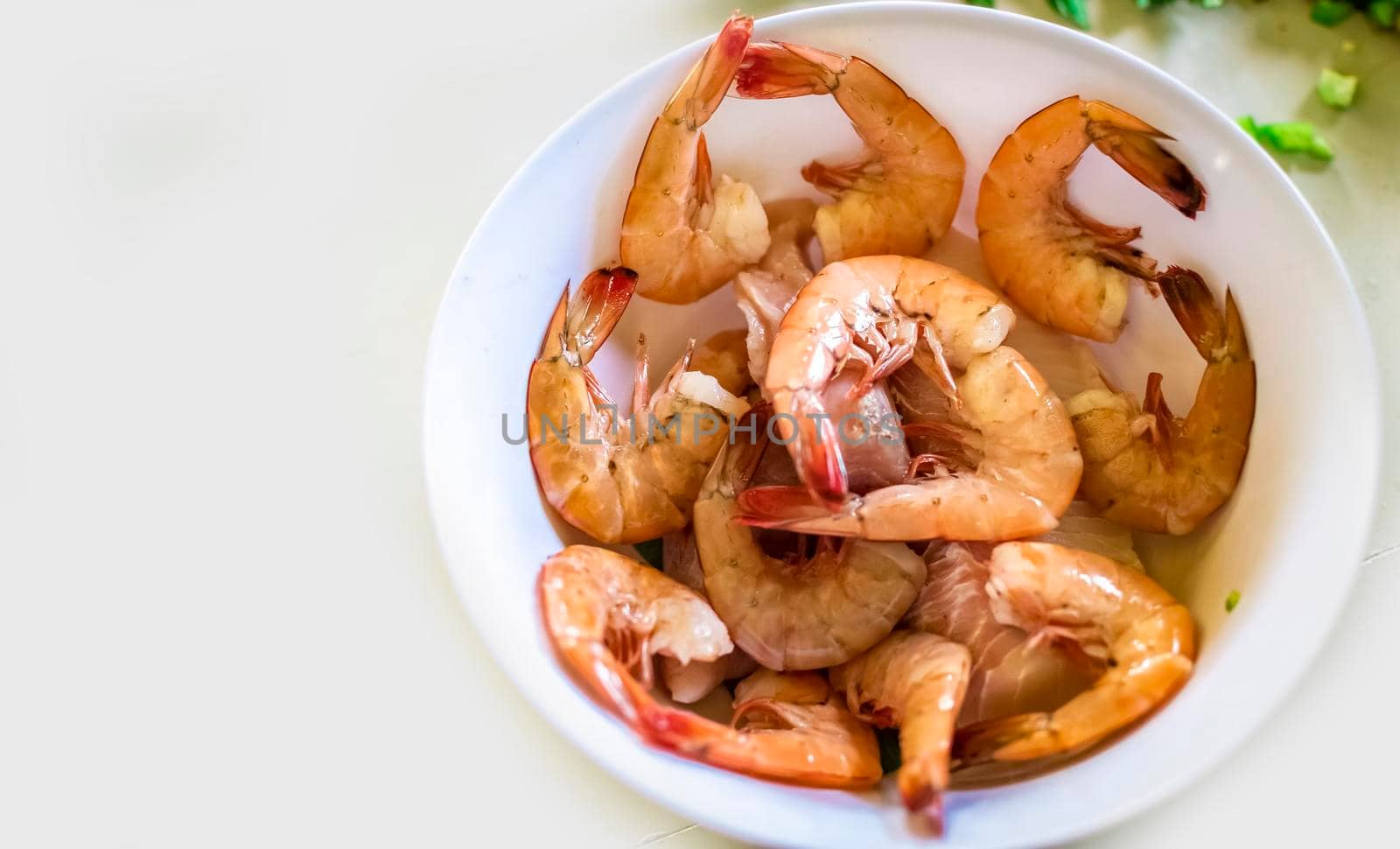 High angle view of raw shrimp on white table, raw shrimp in bowl on white table