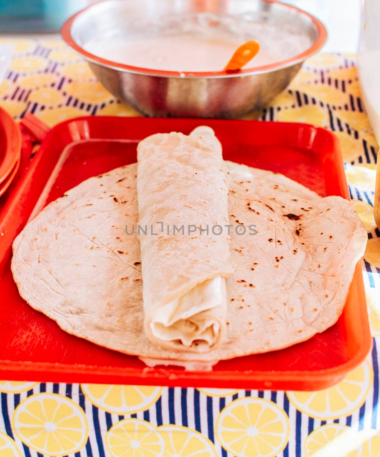 Food Traditional Large Quesillo served on table. Nicaraguan cheese made and served on the table. Traditional cheese with pickled onion and wrapped tortilla, Traditional Nicaraguan Quesillo by isaiphoto