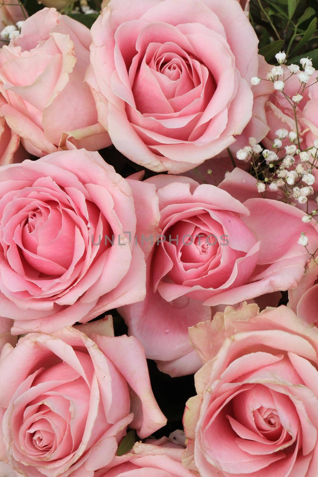 Big pink roses in a floral wedding decoration by studioportosabbia