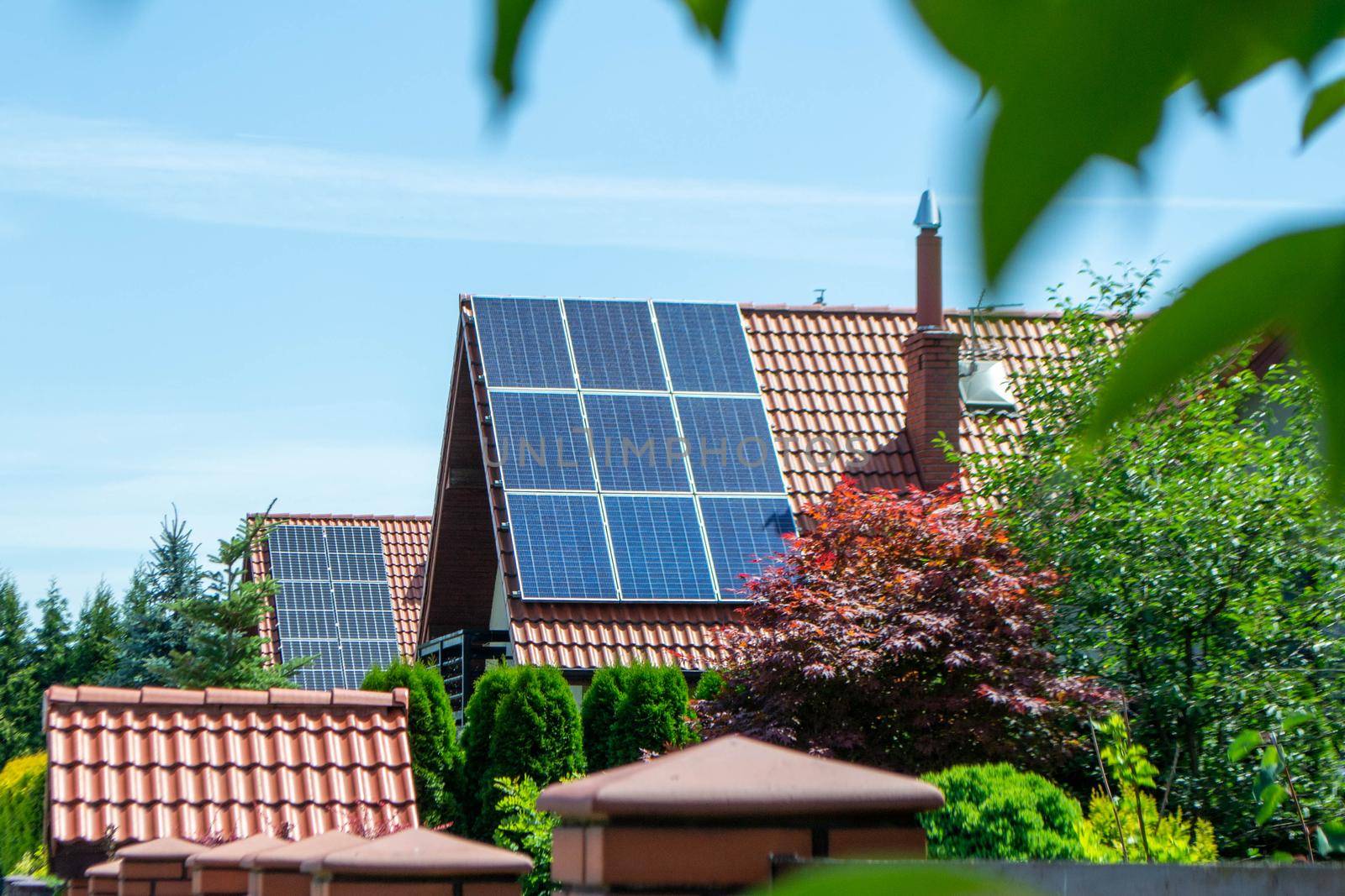 House roof with photovoltaic modules. Historic farm house with modern solar panels on roof and wall High quality photo