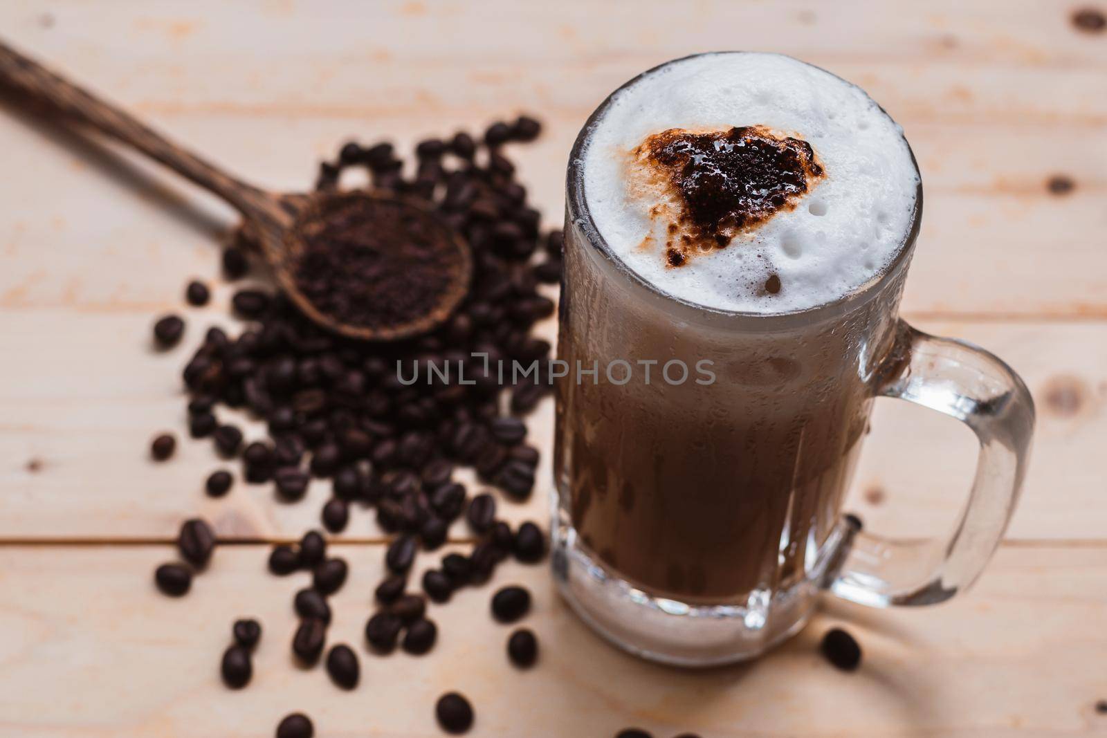 Top view selective focus of iced coffee froth in coffee mug cup. by wattanaphob