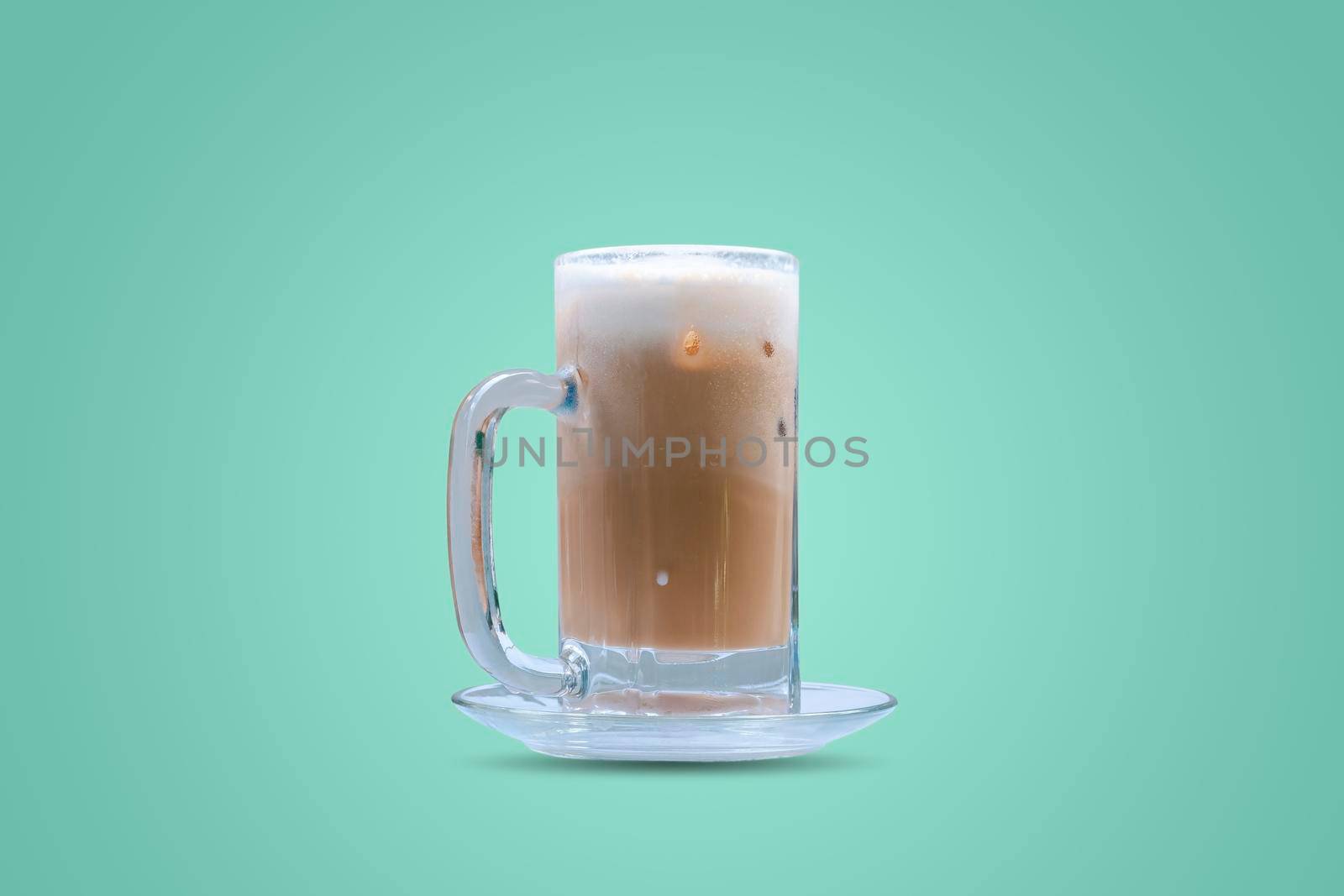 Iced coffee in a glass on green pastel color background. by wattanaphob