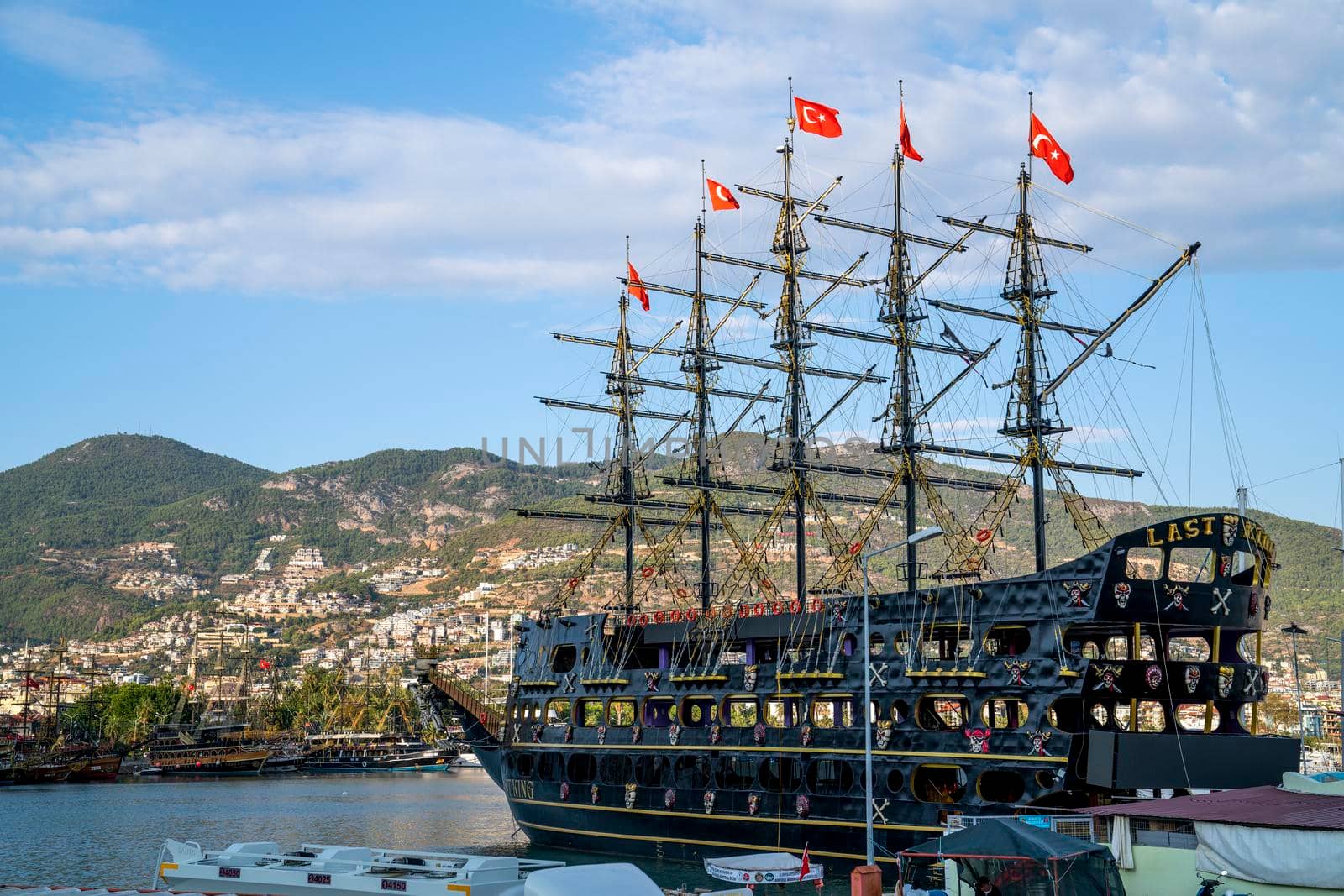 Turkey, Alanya - November 9, 2020: Walking ship stand in port of Alanya. Bay of ships.