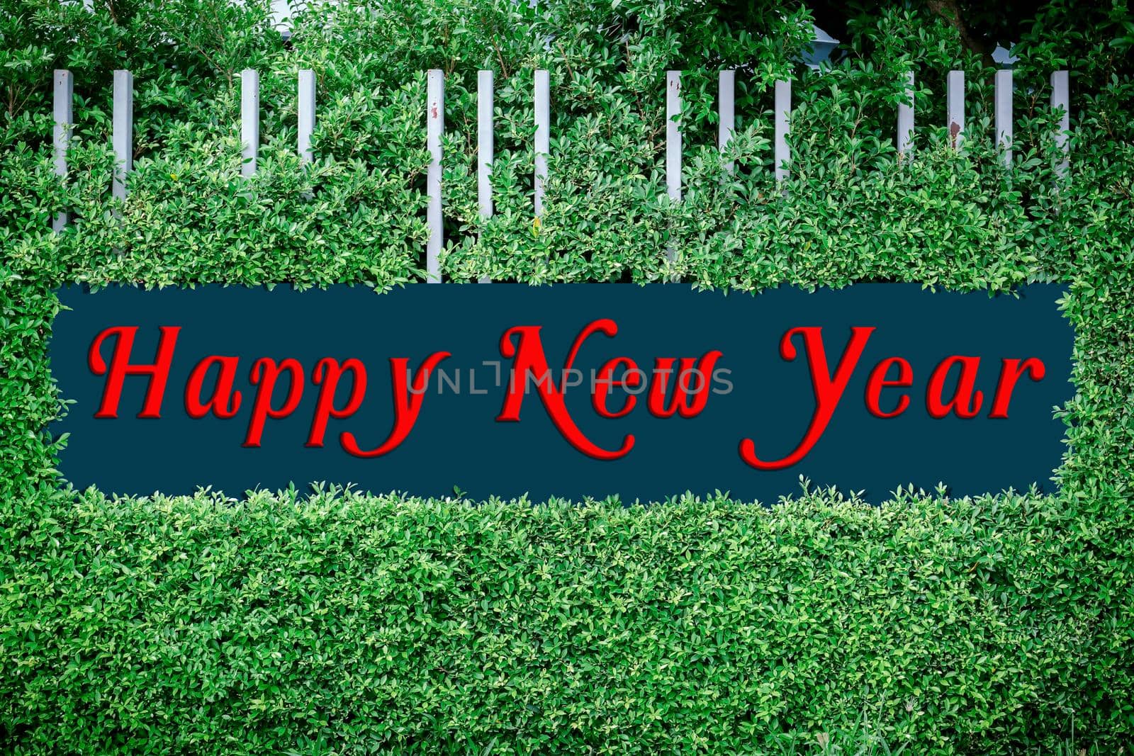 Happy new year texts logo on the framed by green leaves, use happy new year concept.