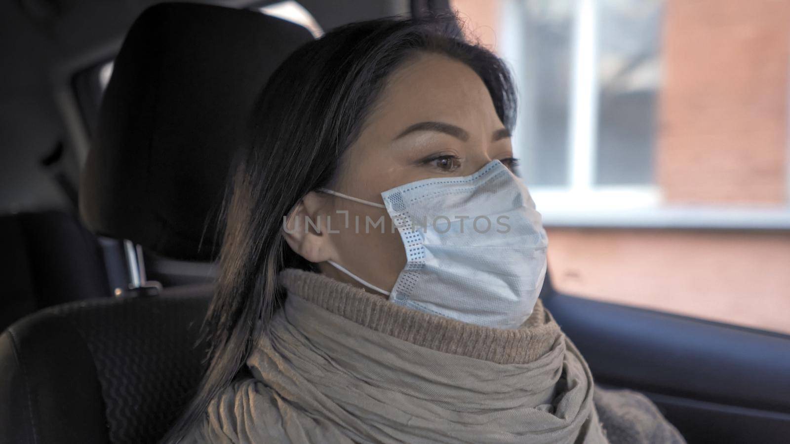 Woman Driving Car, Asian Woman Wearing Protective Mask Drives To Work Past City Buildings During The Quarantine Period Of COVID 19, Work And Earnings During Pandemic