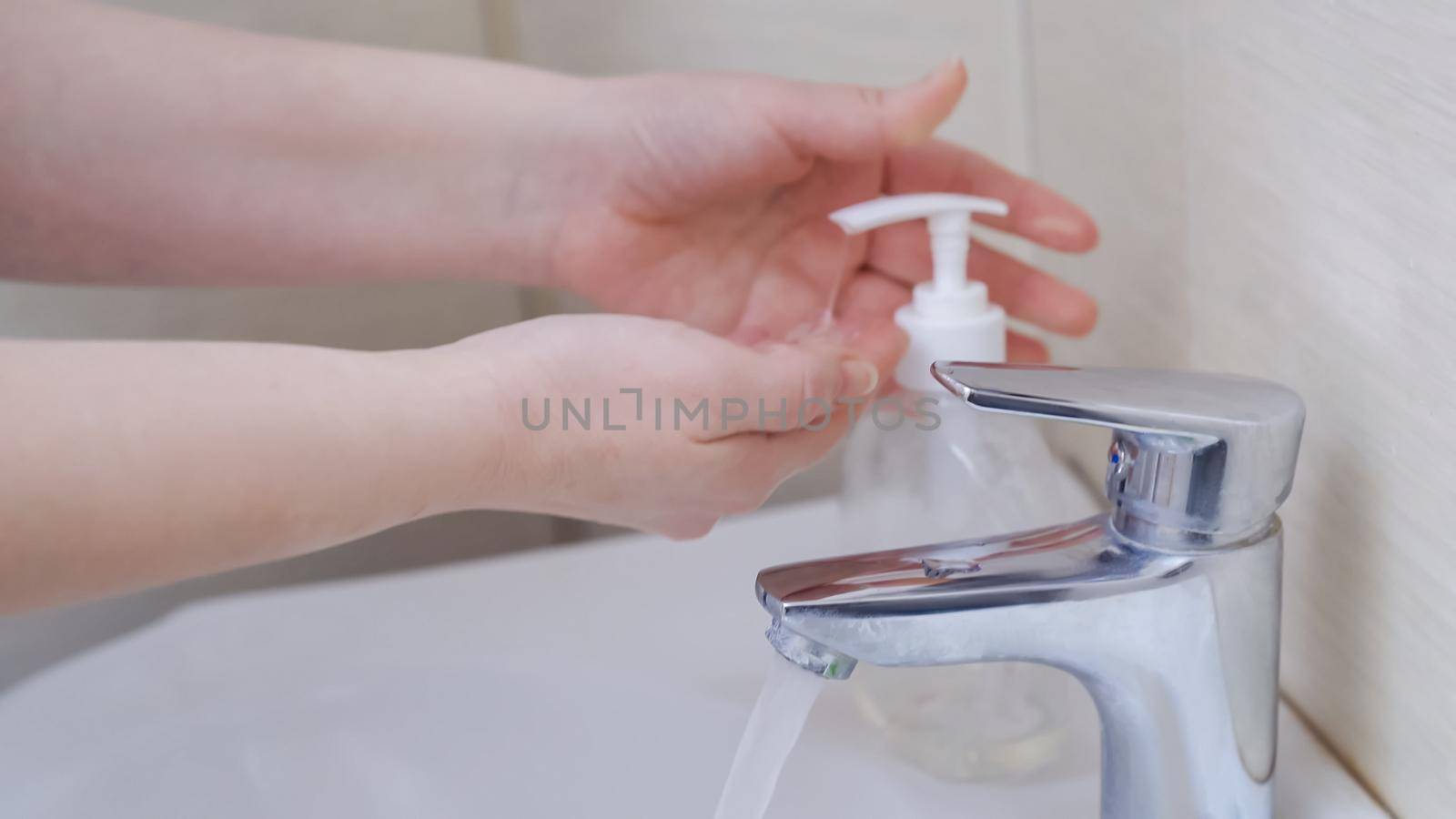 Female Hands Demonstrate Hygiene Rules During An Epidemic Of A Coronavirus, Caucasian Woman Washing Her Hands With Antibacterial Soap, Side View, Close Up Shot