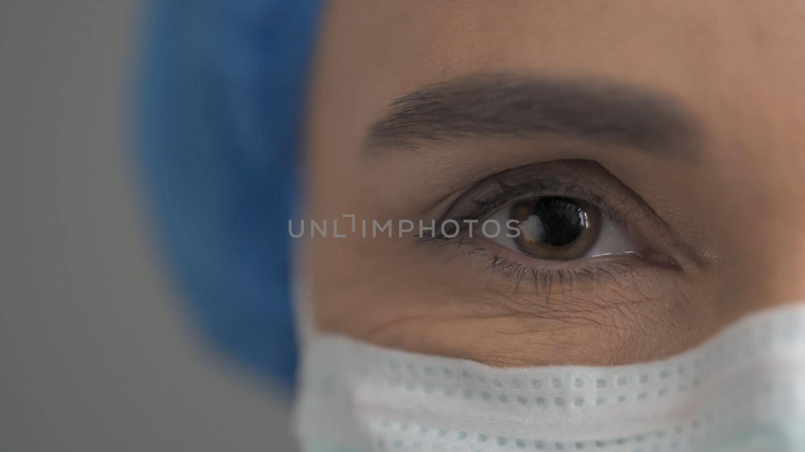 Close Up Of Doctor's Eyes, Female Face In Protective Mask Looking At Camera, Beautiful Female Brown Eye With Copy Space On The Left Side, Quarantine Concept, Front View