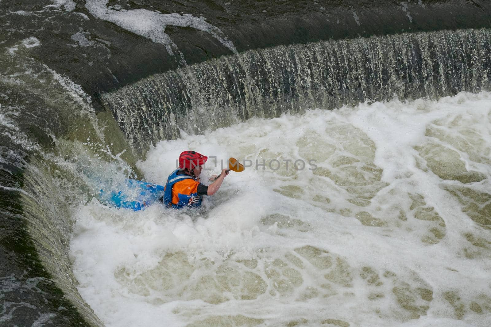 Bath, England, United Kingdom - August 4, 2021: Kayaking over Pulteney Weir on the River Avon in the historic city of Bath in the United Kingdom