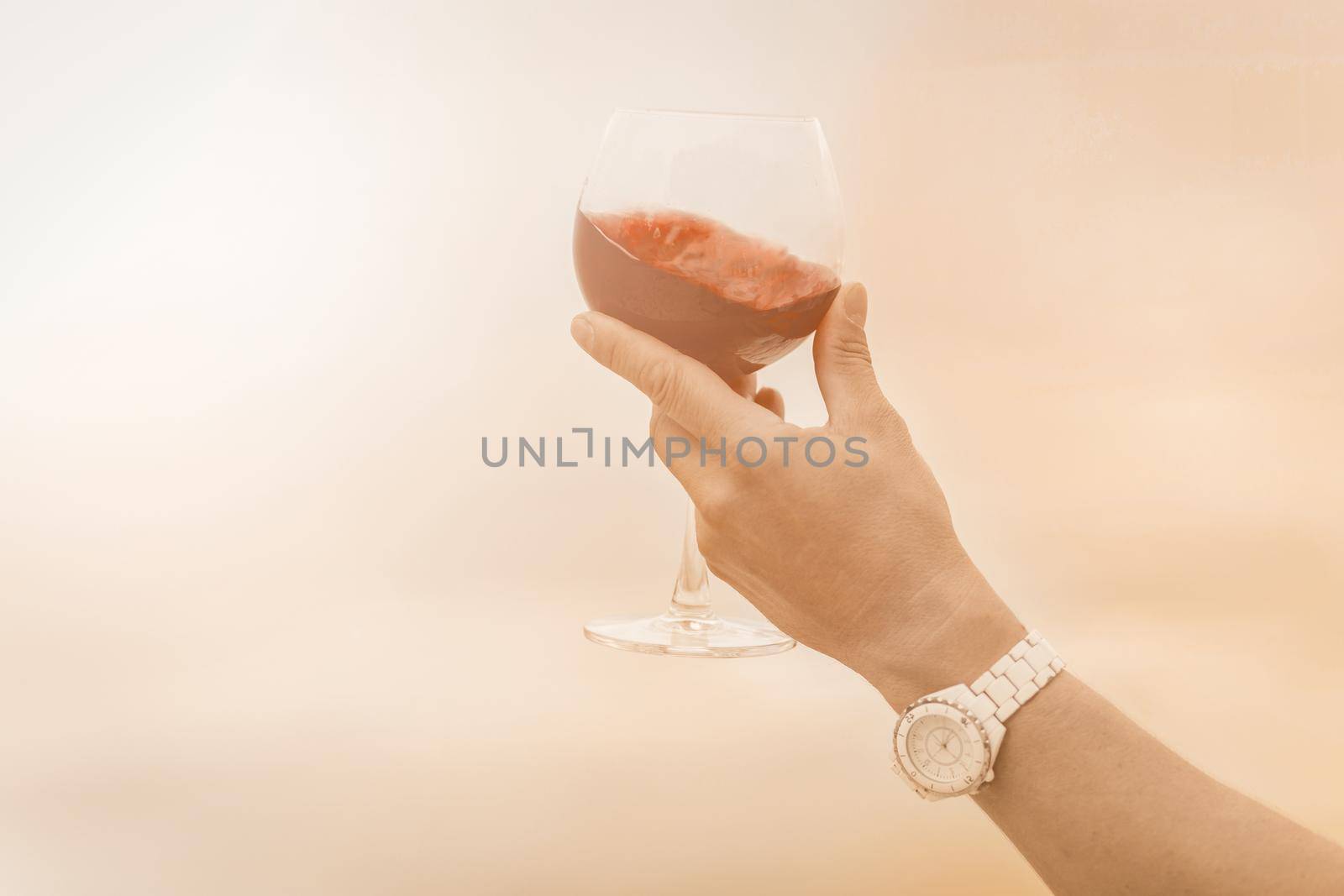 sommelier hand with Red glass of wine in retro style. Celebration and party. Healthy lifestyle. Red background. Holiday celebration.