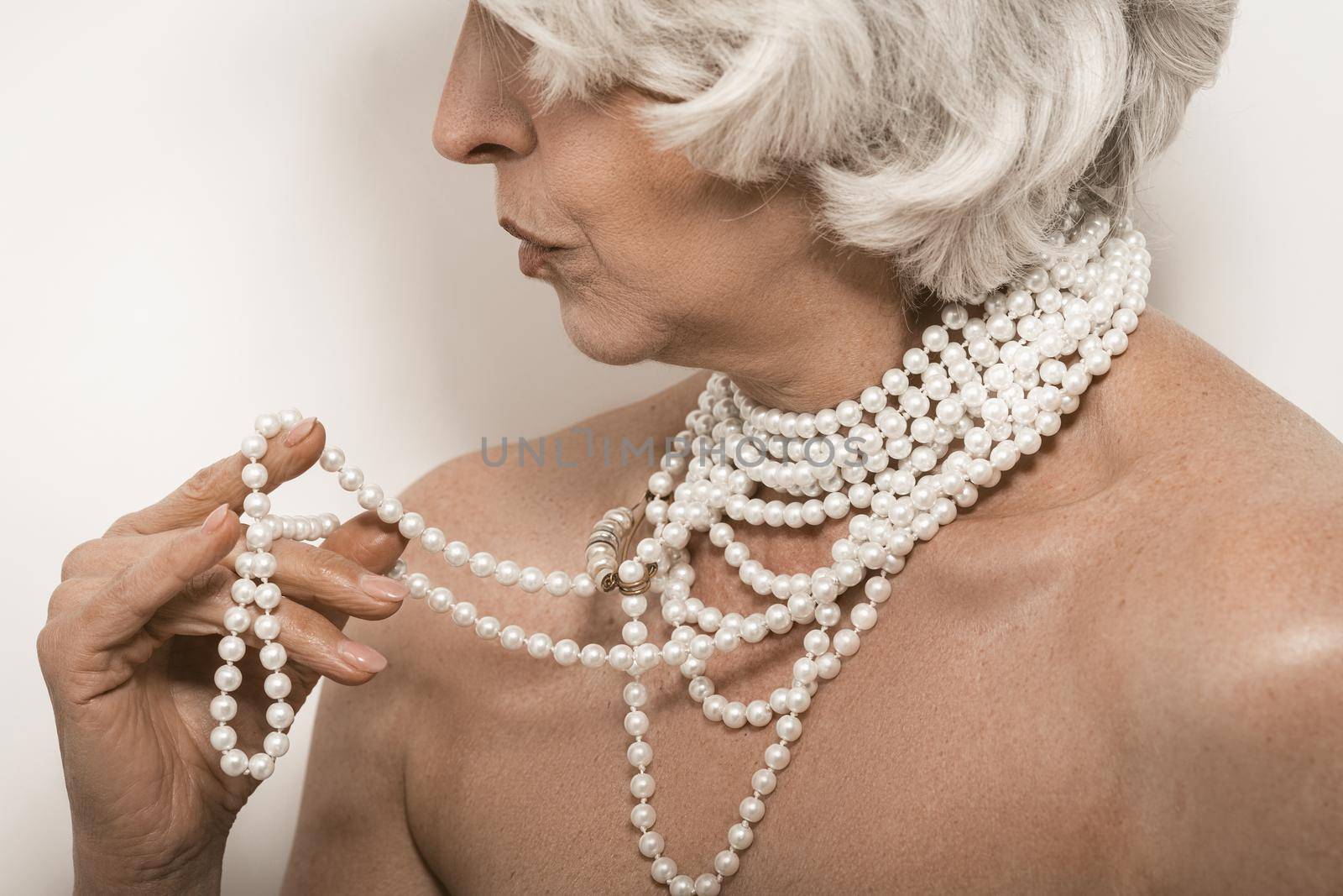 Classic portrait. White background. Beautiful old woman face. Beauty portrait. Older people. White background.