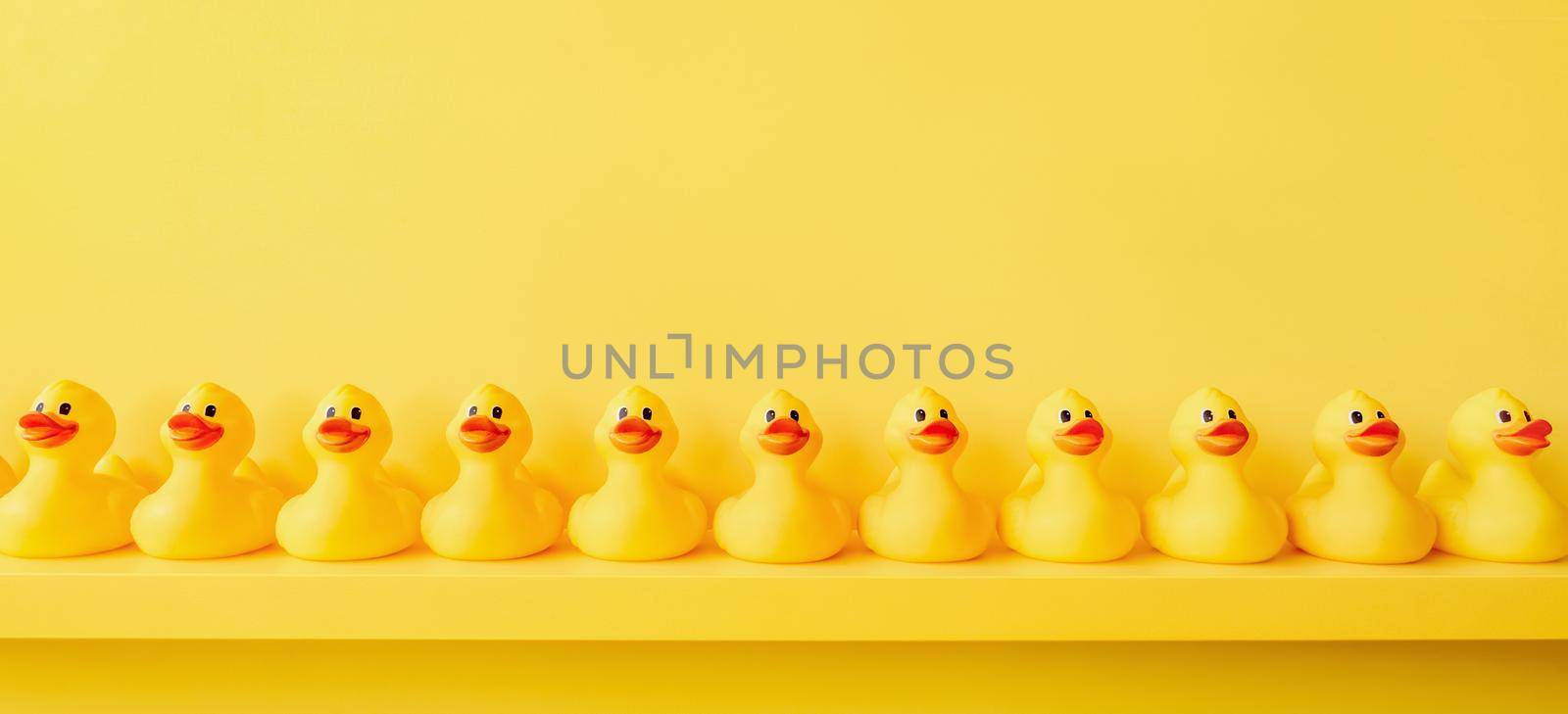 Banner yellow rubber duck background yellow ducks in a row. Rubber duck pattern yellow concept. Communication. Community. Rubber ducky bath toy duckling bathroom shelf toy design shelf decor. Organize by synel