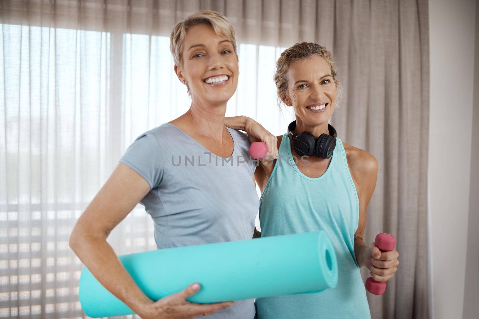Surrounded by those who just do better. Portrait of two mature women getting ready for their workout at home