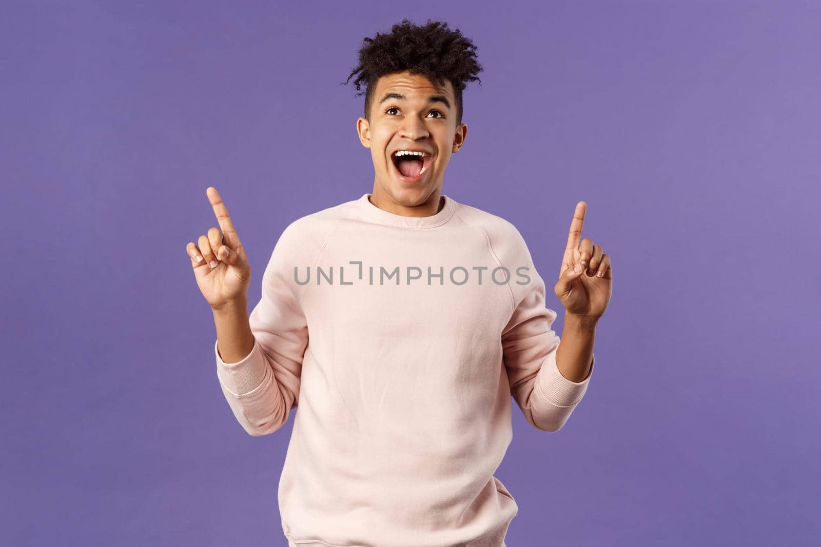 Charismatic good-looking young 25s hispanic guy rejoicing over super cool offer, best deal ever, seeing favorite product finally in stock, pointing fingers up smiling and laughing from happiness.