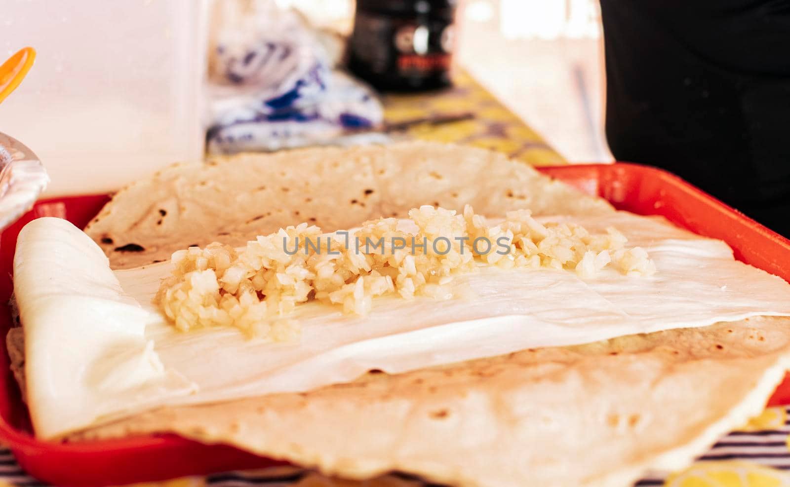 Traditional Quesillo with pickled onion, Preparation of Traditional Nicaraguan Quesillo. Person making delicious Nicaraguan cheese. Hands preparing the traditional Nicaraguan Quesillo
