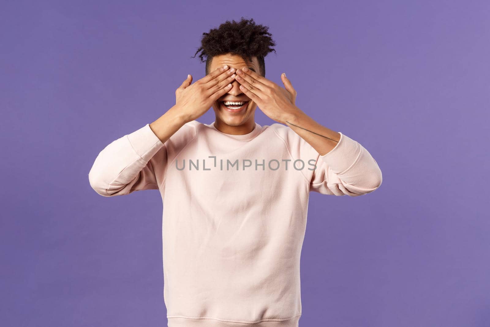 Portrait of surprised and excited, amused happy birthday guy close eyes and count ten to see what friends brought as gift, anticipating present, awaiting with cheerful expression, purple background.