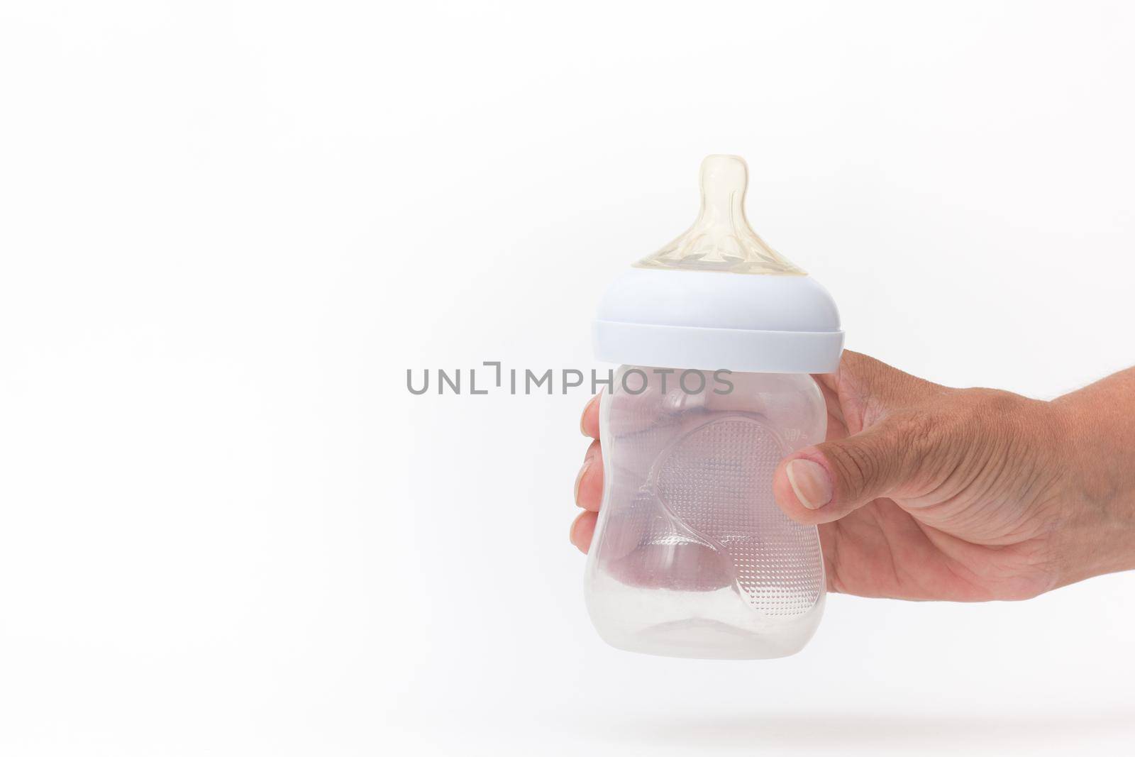 Empty bottle feeding in cropped woman hand on white background by TatianaFoxy