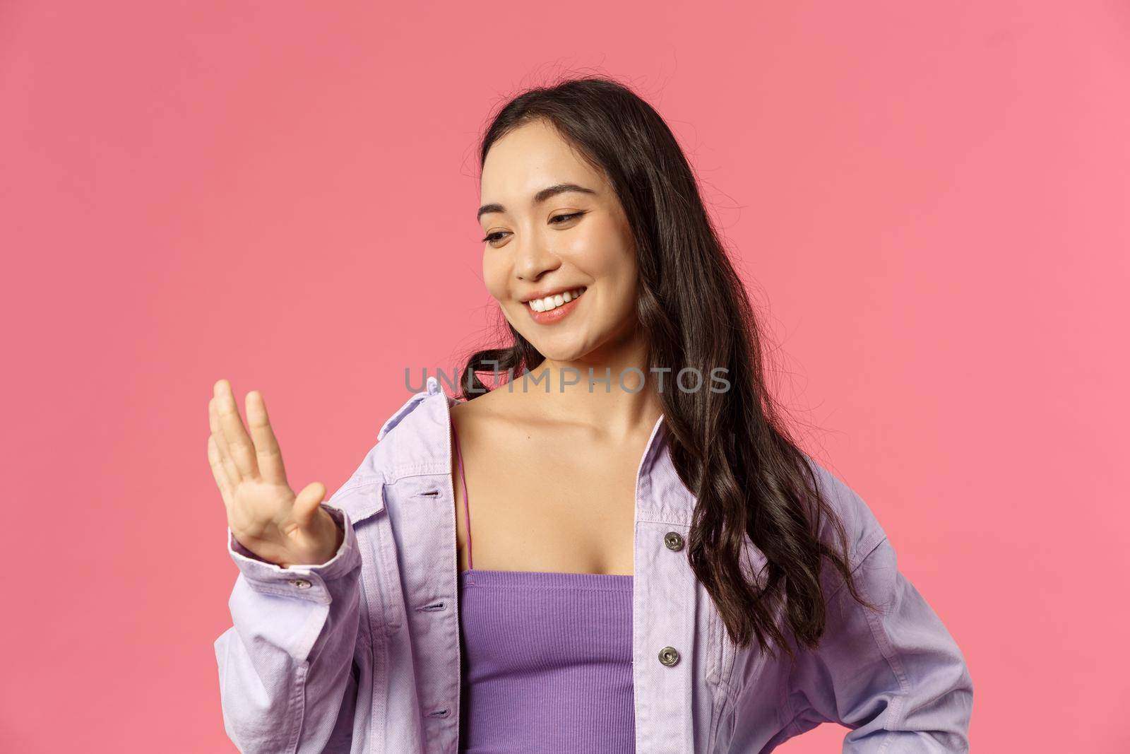 Close-up portrait of pleased good-looking asian girl pleased with great neat manicure, looking at her fingers with smiling satisfied expression, visited nails salon, standing pink background by Benzoix