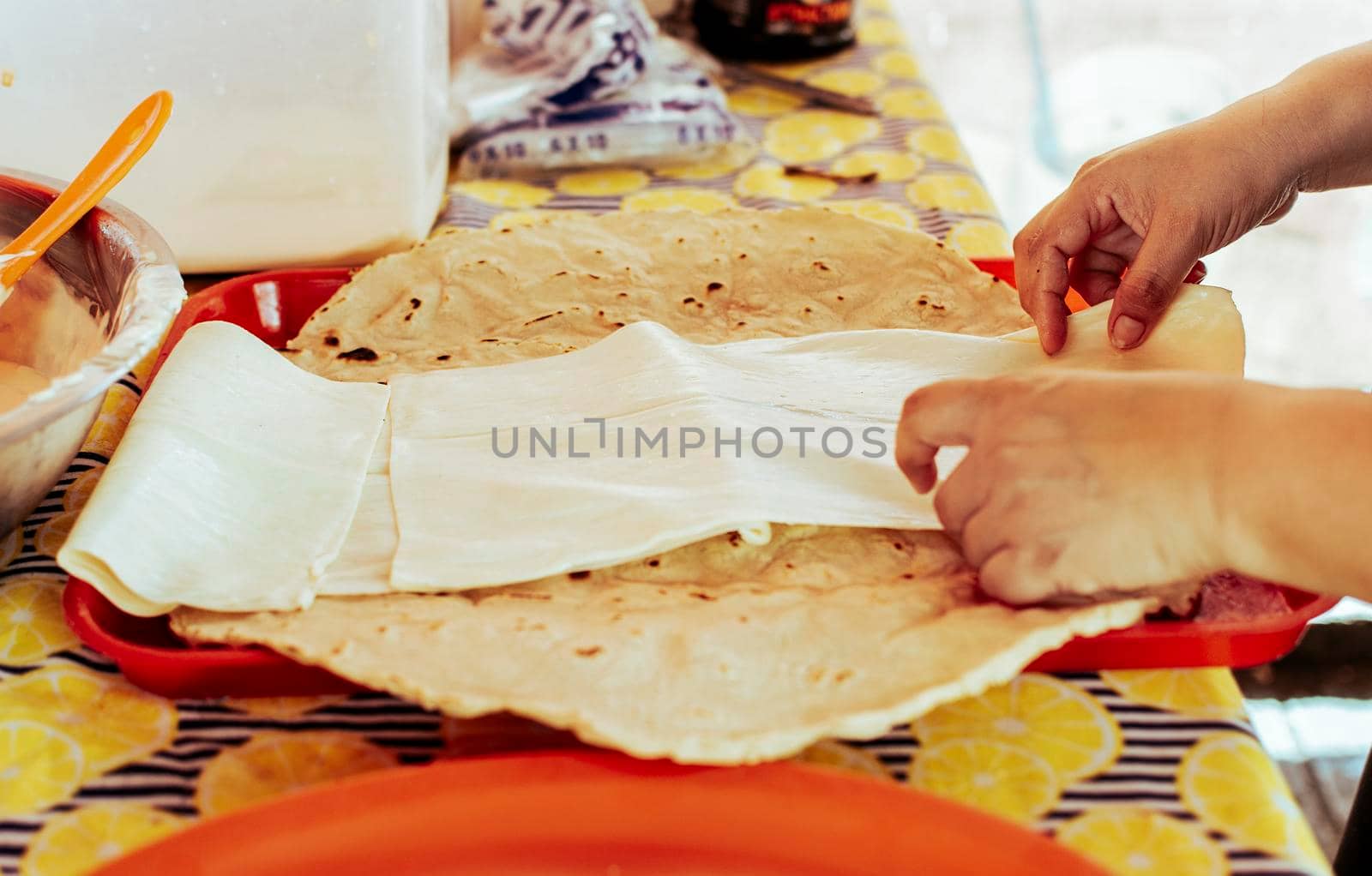 Preparation of Traditional Nicaraguan Quesillo. Person making delicious Nicaraguan cheese. Traditional cheese with pickled onion, Hands preparing the traditional Nicaraguan Quesillo by isaiphoto