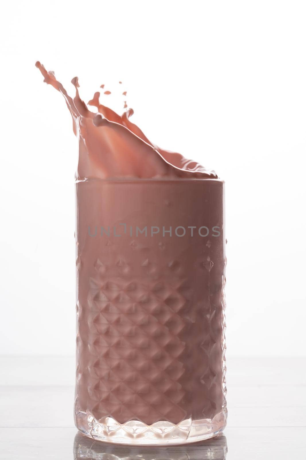 strawberry milkshake with natural fruit splash effect white background and copy-space