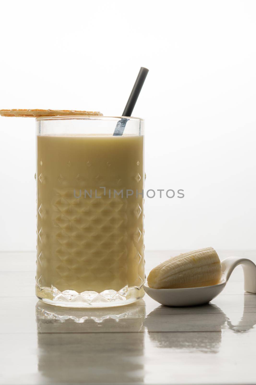 banana milkshake with fresh fruit and cookie white background and copy-space