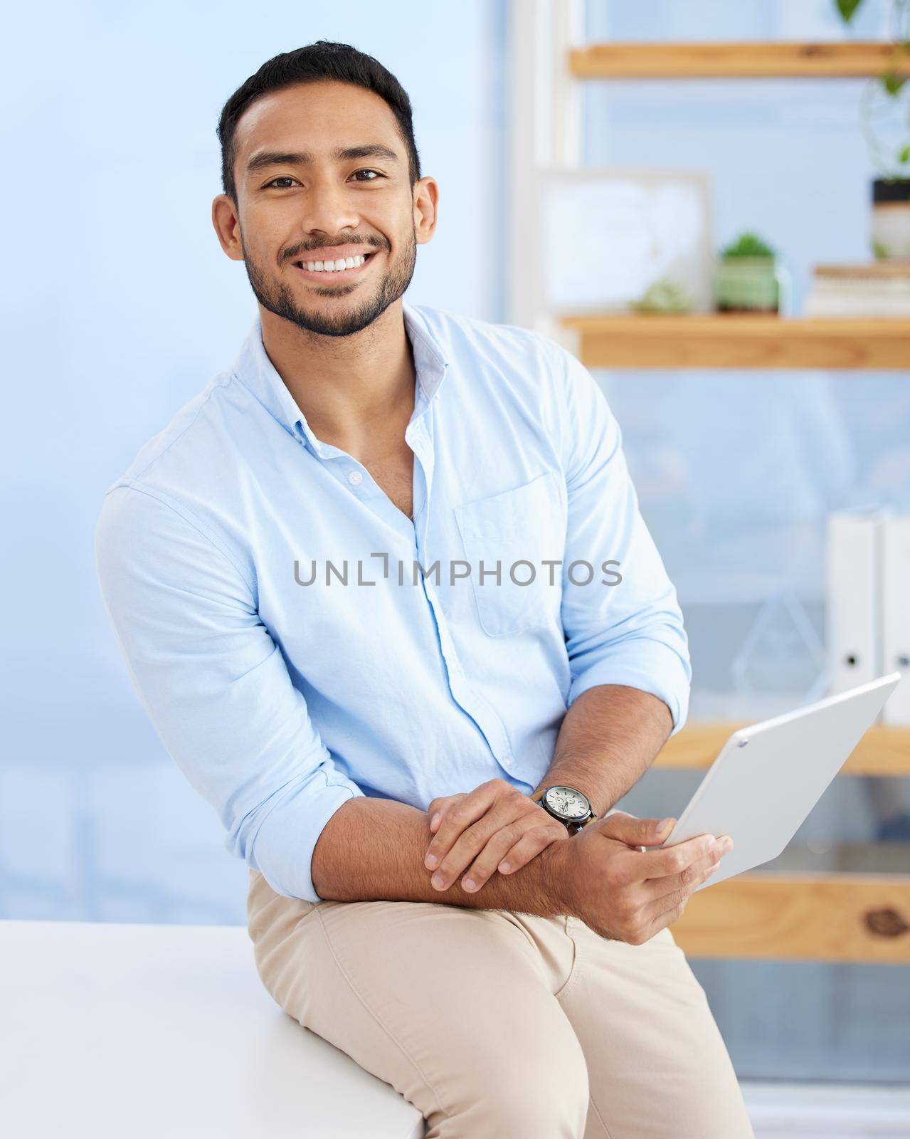 Technology makes finding clients easier. a young businessman sitting on a desk at work
