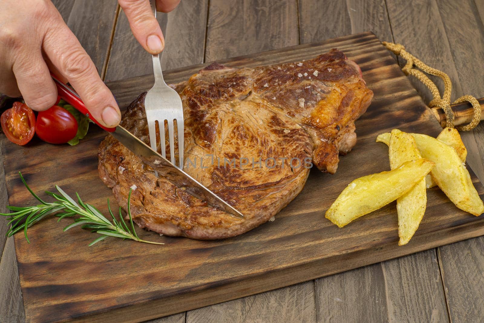 veal chop with potatoes and vegetables by joseantona