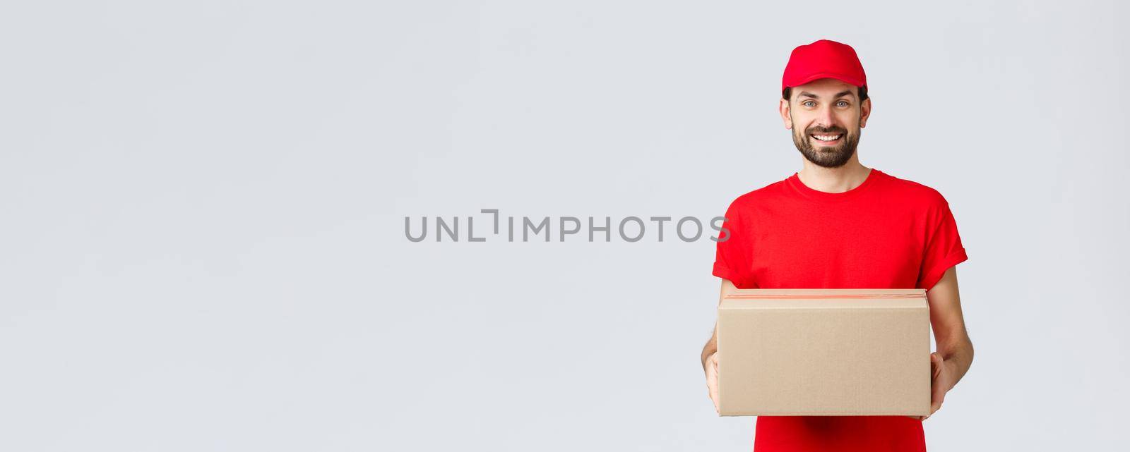Order delivery, online shopping and package shipping concept. Smiling friendly courier bring package to client doorstep. Employee in red service cap and t-shirt holding box, parcel for customer.