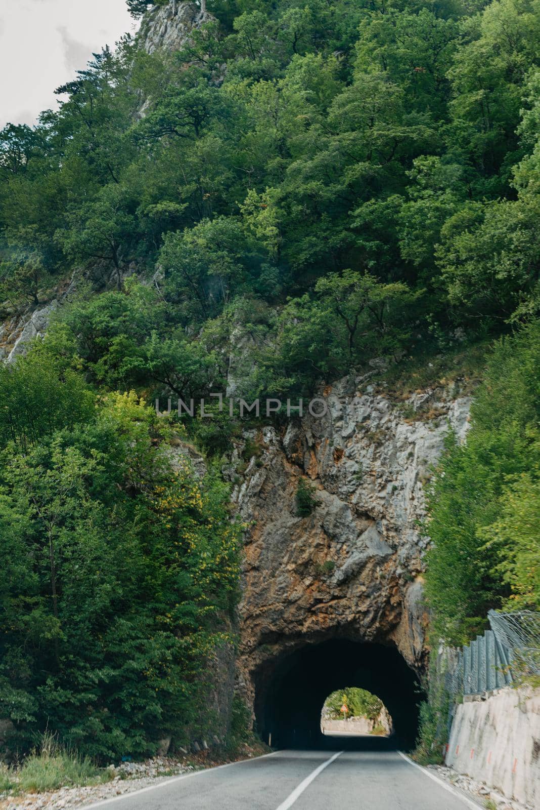 Empty route and small tunnel in mountain.