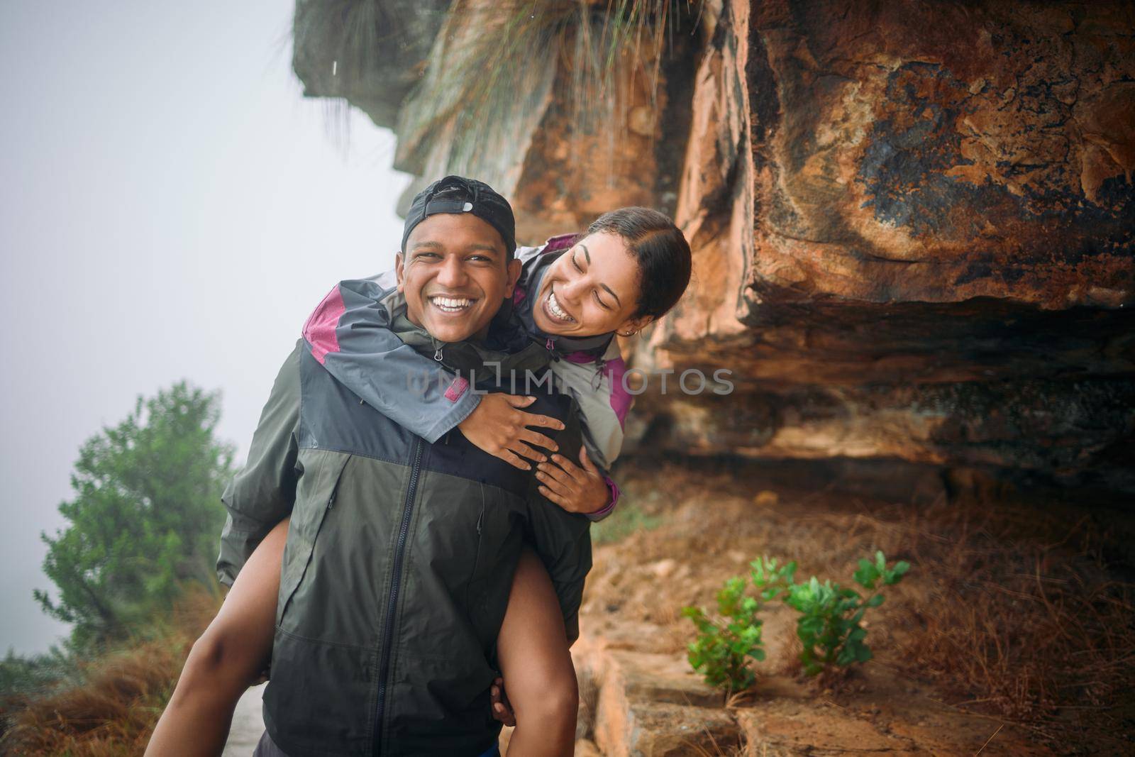 Life with you is nothing but a beautiful adventure. a young couple wearing their rain jackets while out hiking