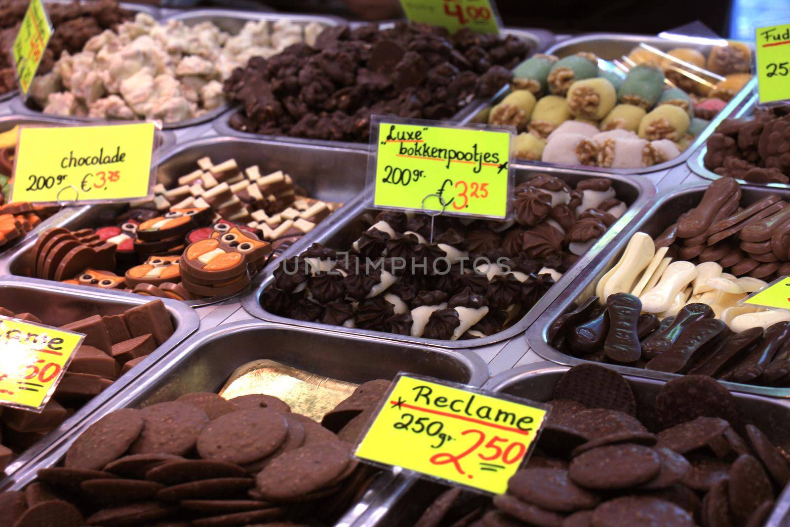 Chocolates on display on a confectioner's market stall (tags: prices and product information in Dutch, special offer and typical Dutch dark chocolate marzipan)