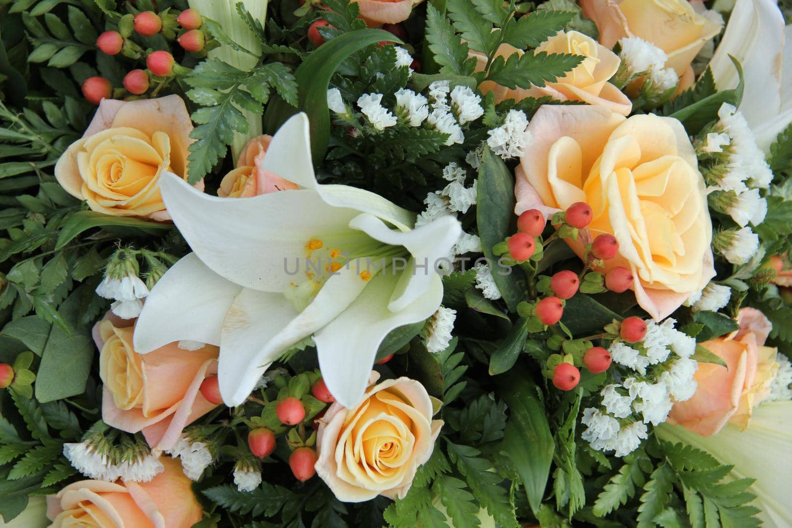 White tiger lillies and yellow pink roses in a bridal bouquet