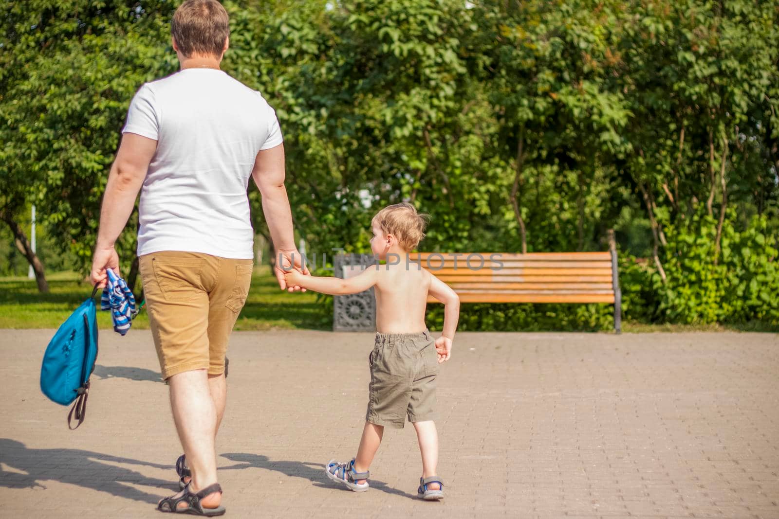 Walking in the park on a summer day by the river and experiencing the joy of walking. summer heat, a child without a T-shirt.  by Alina_Lebed