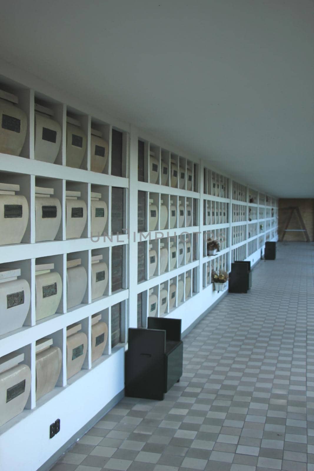 Urns with ashes in a columbarium wall