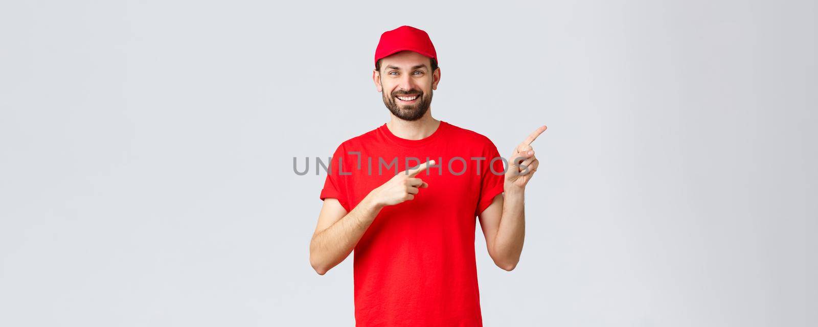 Online shopping, delivery during quarantine and takeaway concept. Smiling cheerful courier inform clients abour special promo, pointing fingers right. Employee recommend click on banner by Benzoix
