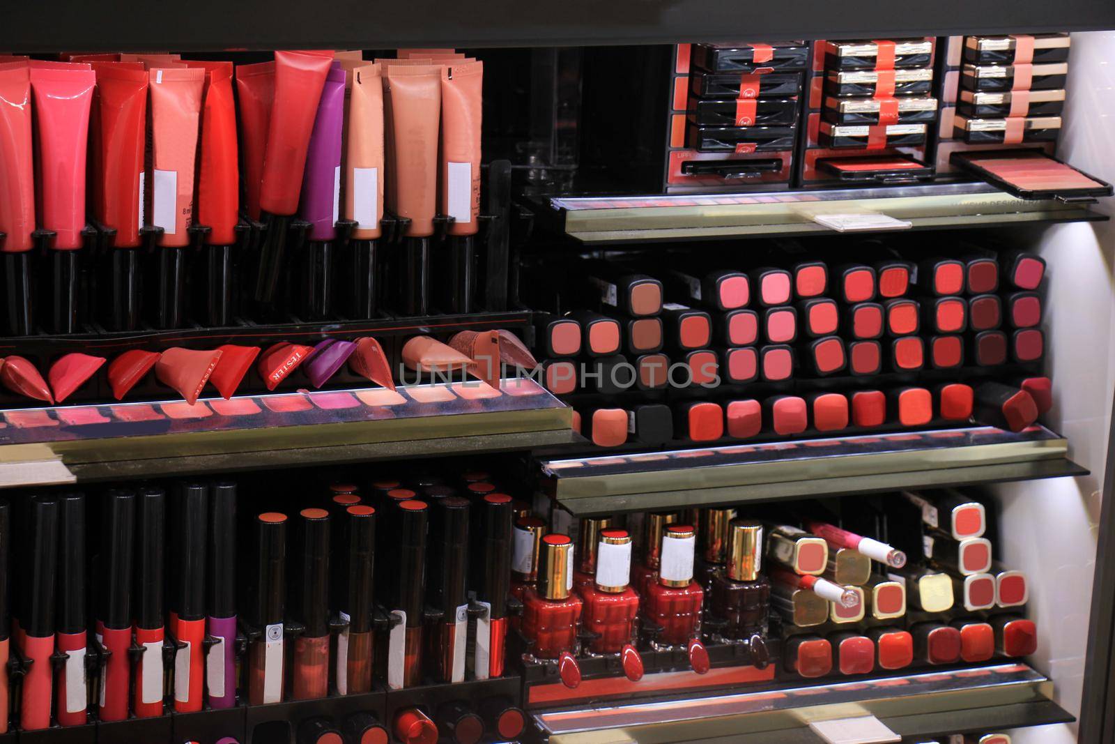 Cosmetics display in a store showing all various colors by studioportosabbia