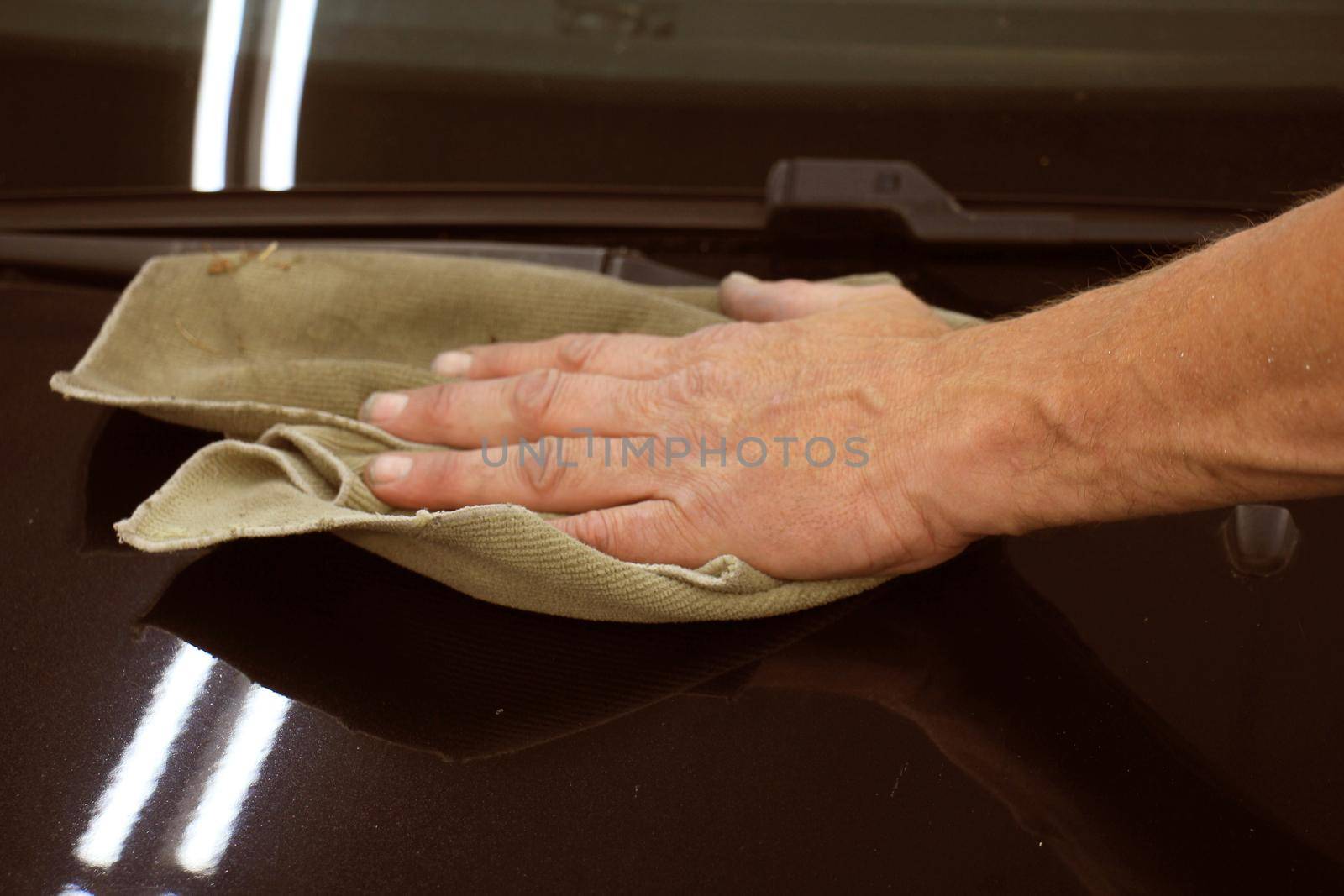 Man polishing a car after a car repair job