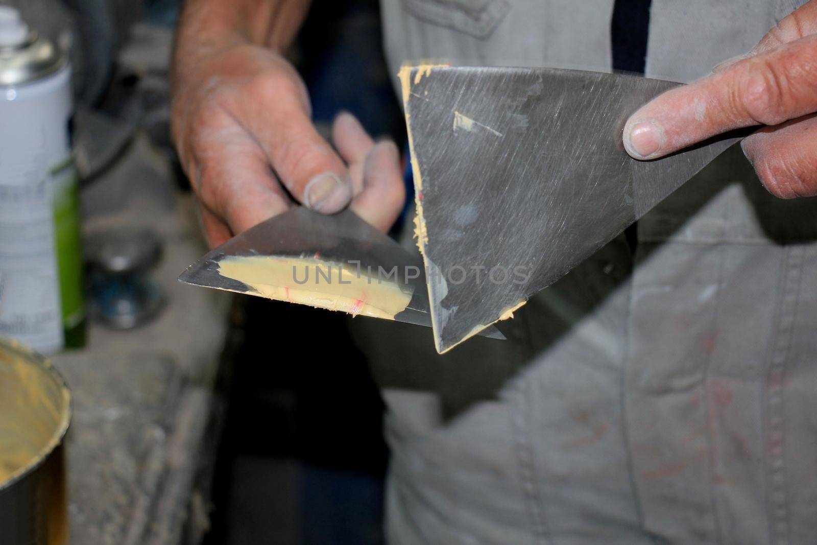 Man preparing filler in a vehicle repair shop