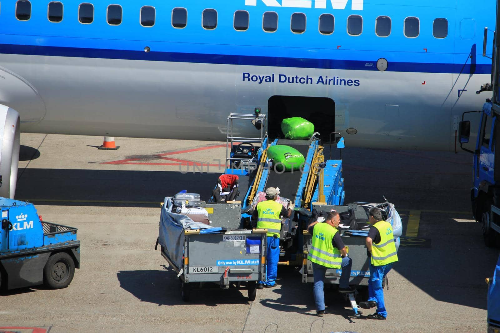 Amsterdam The Netherlands -  May 26th 2017: KLM Boeing 737 parked at gate at Schiphol International Airport, luggage handling