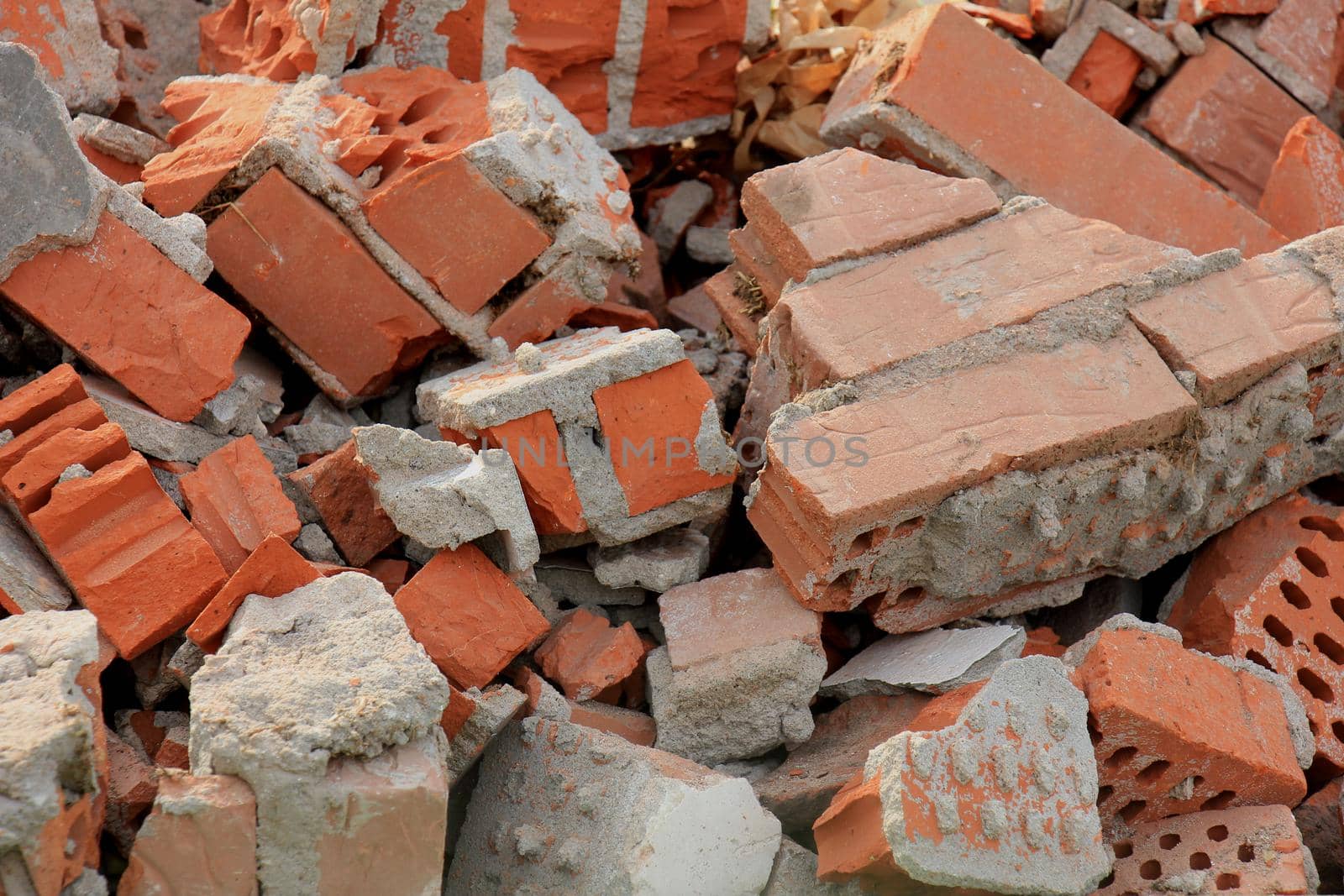 Pile of broken red bricks on construction site