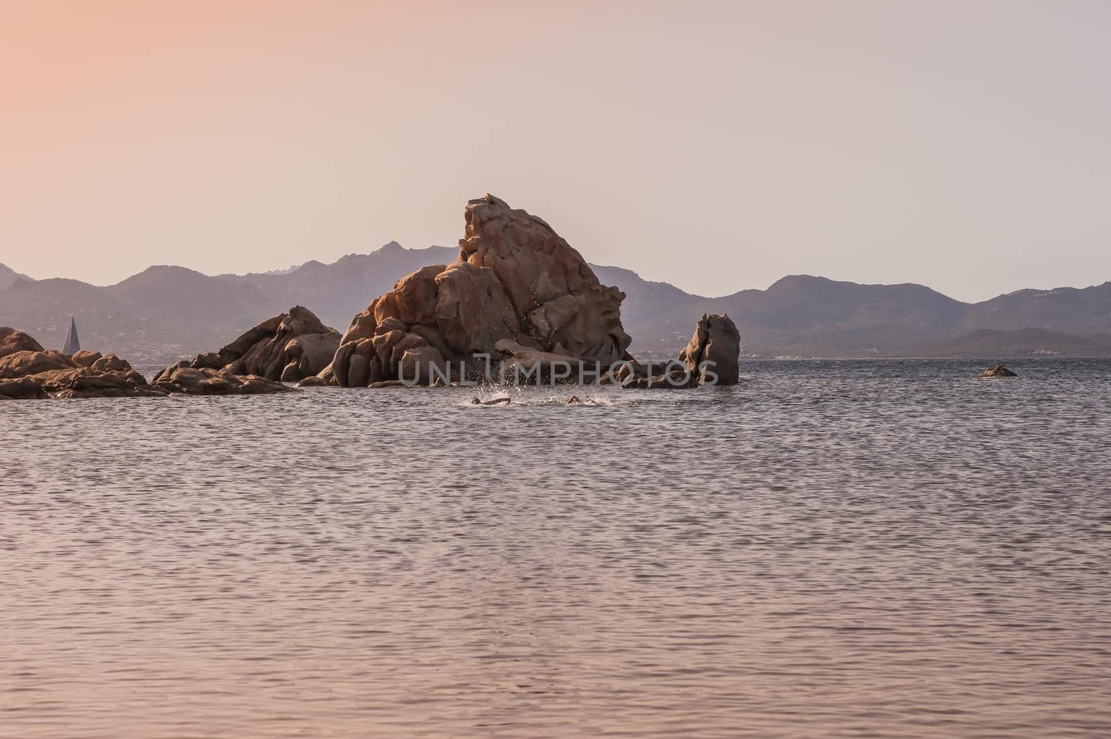 sunset sea with rocks and mountains in the background.beautiful sea.Sardinia