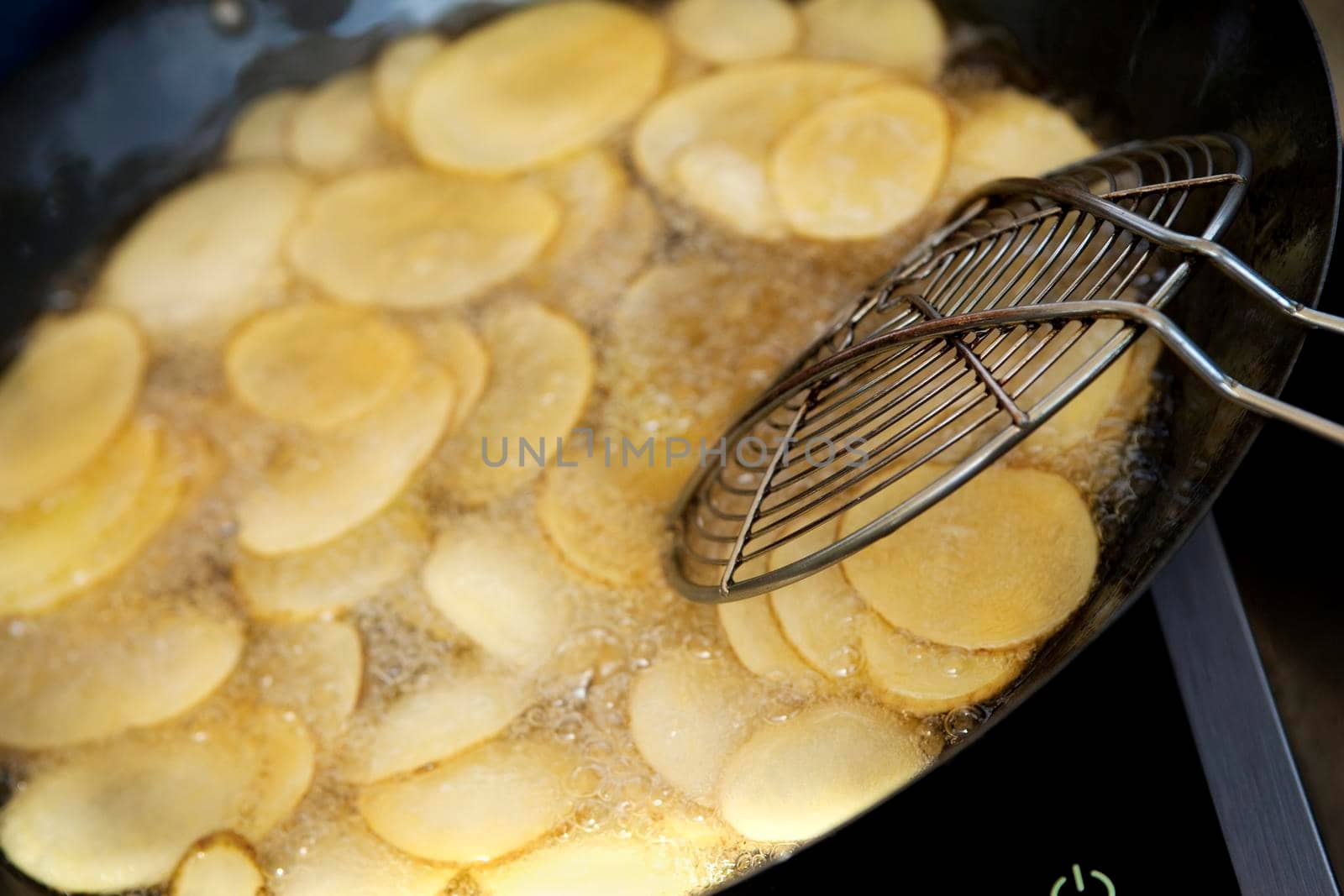 Frying potatoes in the kitchen of a French restaurant