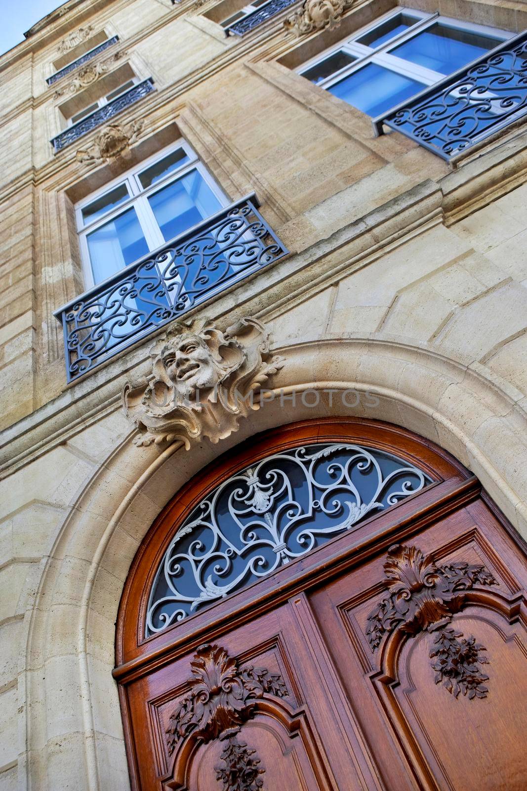 Stylish wooden door and stone facade in Bordeaux, France