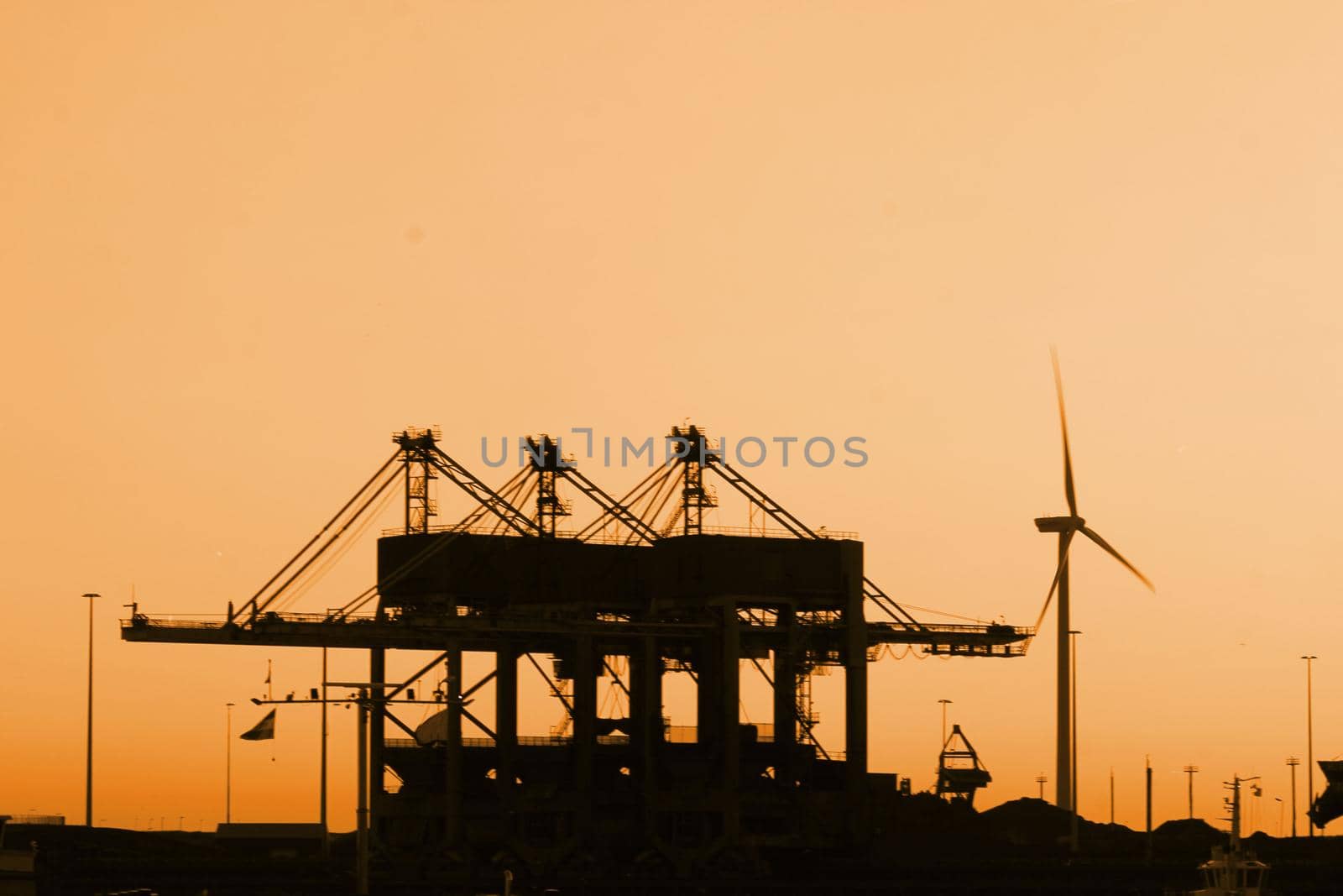 Skyline of an industrial area during sunset by studioportosabbia