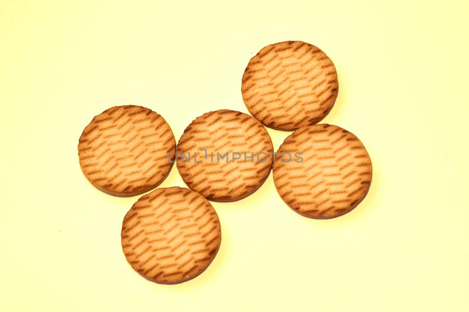 Sweet dessert cookies crekers triangle are a tasty product.Isolated on yellow by jovani68