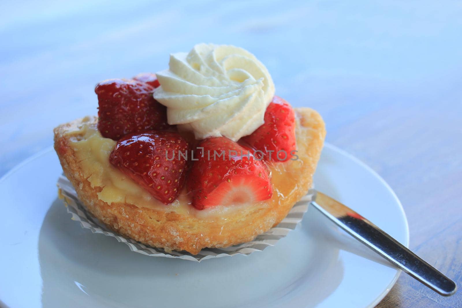 Fresh strawberry confectionery, outside on a table by studioportosabbia