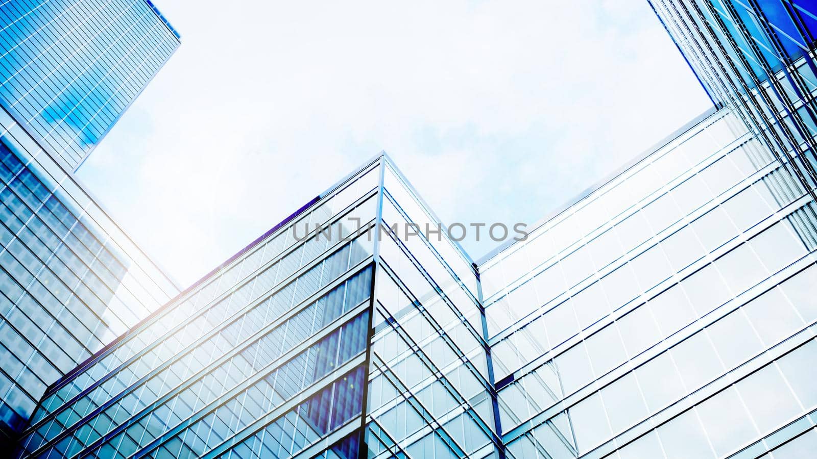 Perfect blue glass high-rise corporate building. Modern office building with glass facade on a clear sky background. Transparent glass wall of office building. 3d Rendering.