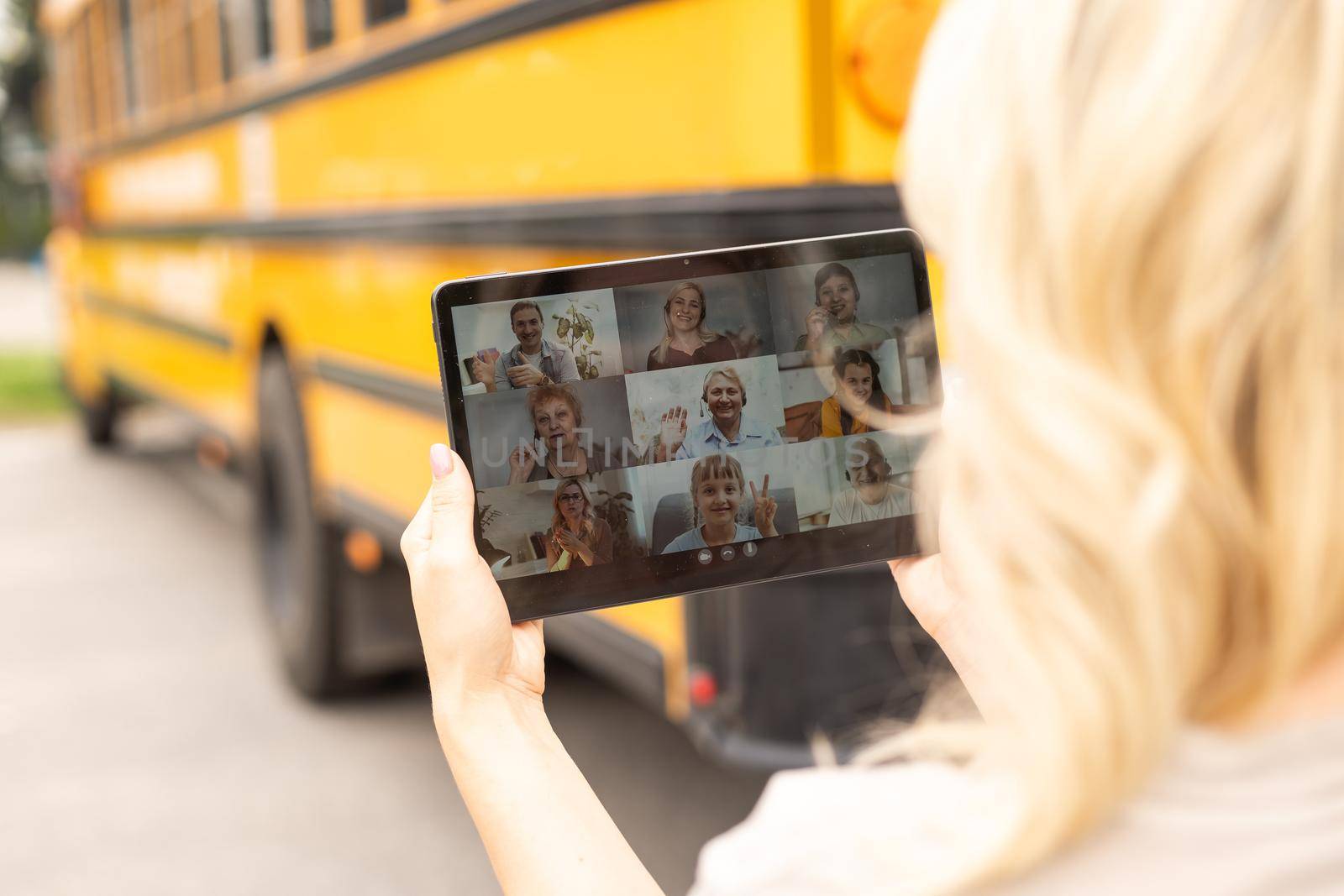 Happy female teacher making video conference chat with students using tablet.