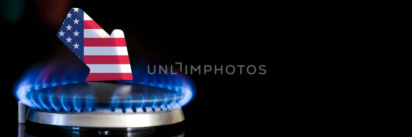 Decreased gas supplies USA. A gas stove with a burning flame and an arrow in the colors of the USA flag pointing down. Concept of crisis in winter and lack of natural gas. Heating season. by SERSOL