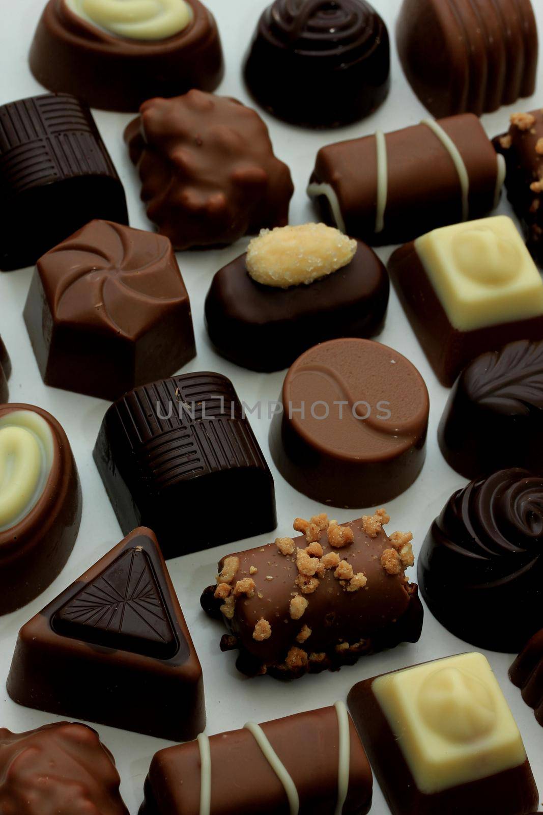 Luxurious chocolates in various shapes and colors by studioportosabbia