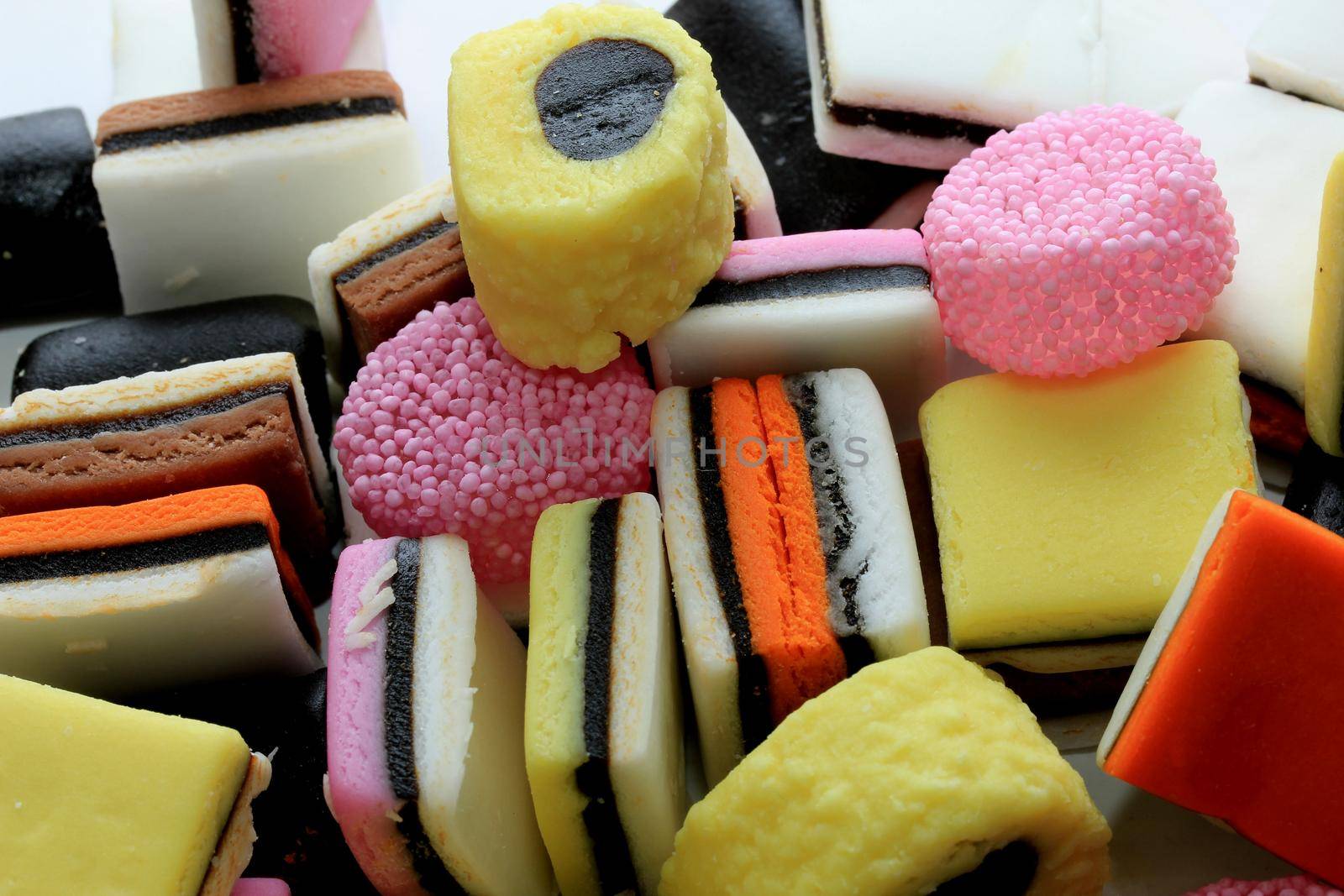 Pile of liquorice allsorts in different shapes, colors and sizes